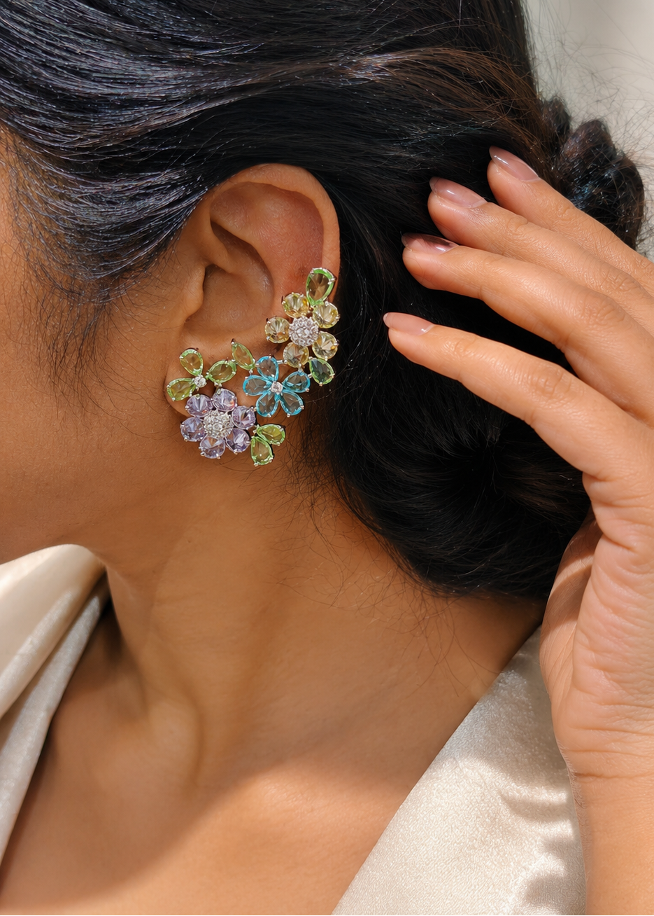 Woman wearing Fleuré Pastel multicolor floral statement ear cuffs with pastel crystal stones and rhodium finish