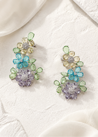 Fleuré Pastel multicolor floral ear cuffs with blue, green, lavender and champagne stones on white textured background