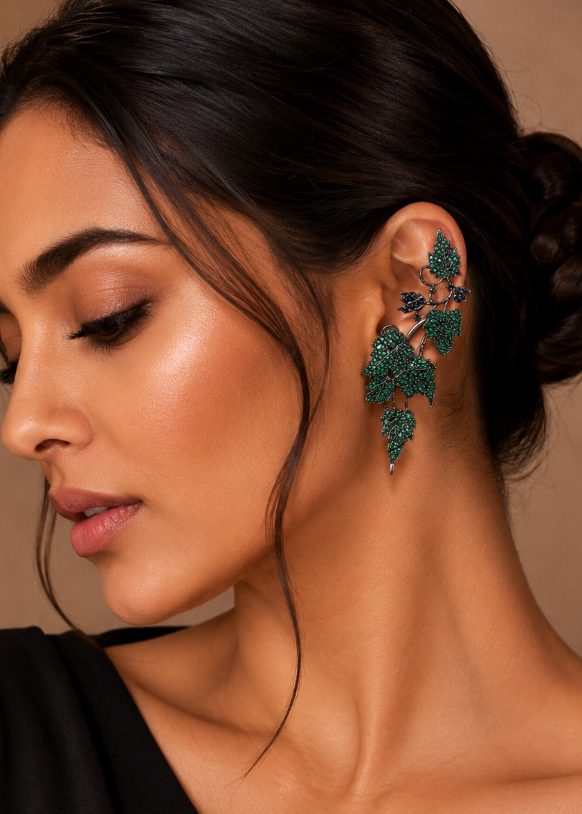 Model wearing Ivy Bloom Green Ear Cuffs with sparkling green stones in a floral-inspired ear climber design