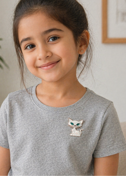 Girl wearing Kitty Charm White Cat Brooch on a light grey t-shirt