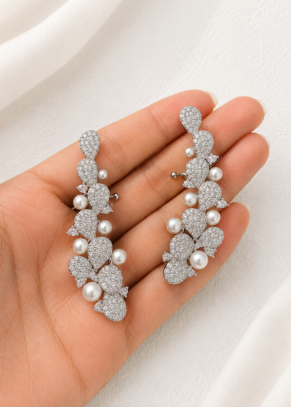 Close-up of Lunaria Pearl Ear Cuff Set showcasing pavé cubic zirconia crystals and pearl details in a silver finish.