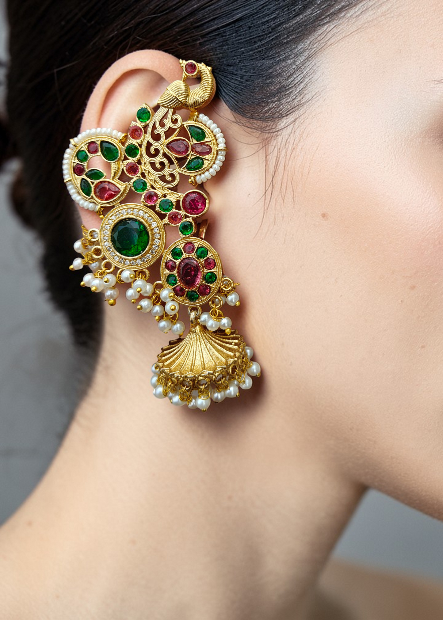 Rajsi Emerald Ruby Ear Cuff worn by a model featuring pearl jhumka drops and floral zircon detailing.