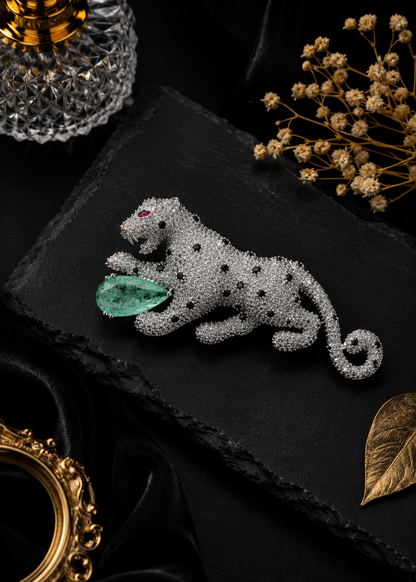 Regal Mint Green Panther Brooch featuring crystal detailing, black stone accents, and a mint green gemstone centerpiece on a black slate display
