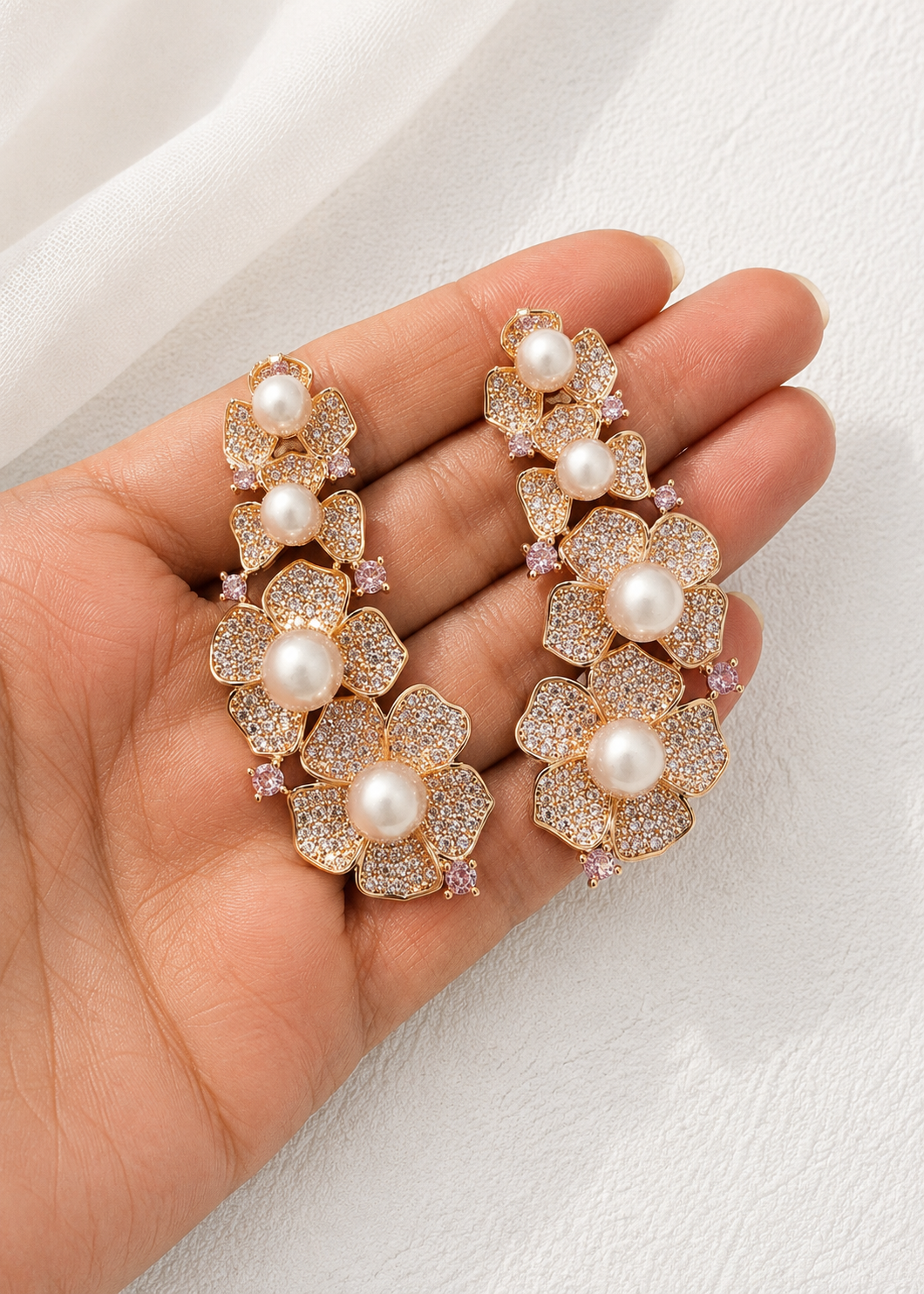 Close-up of Rosalie Pearl Ear Cuff Set showcasing sparkling floral cubic zirconia design with pearl accents and gold finish.