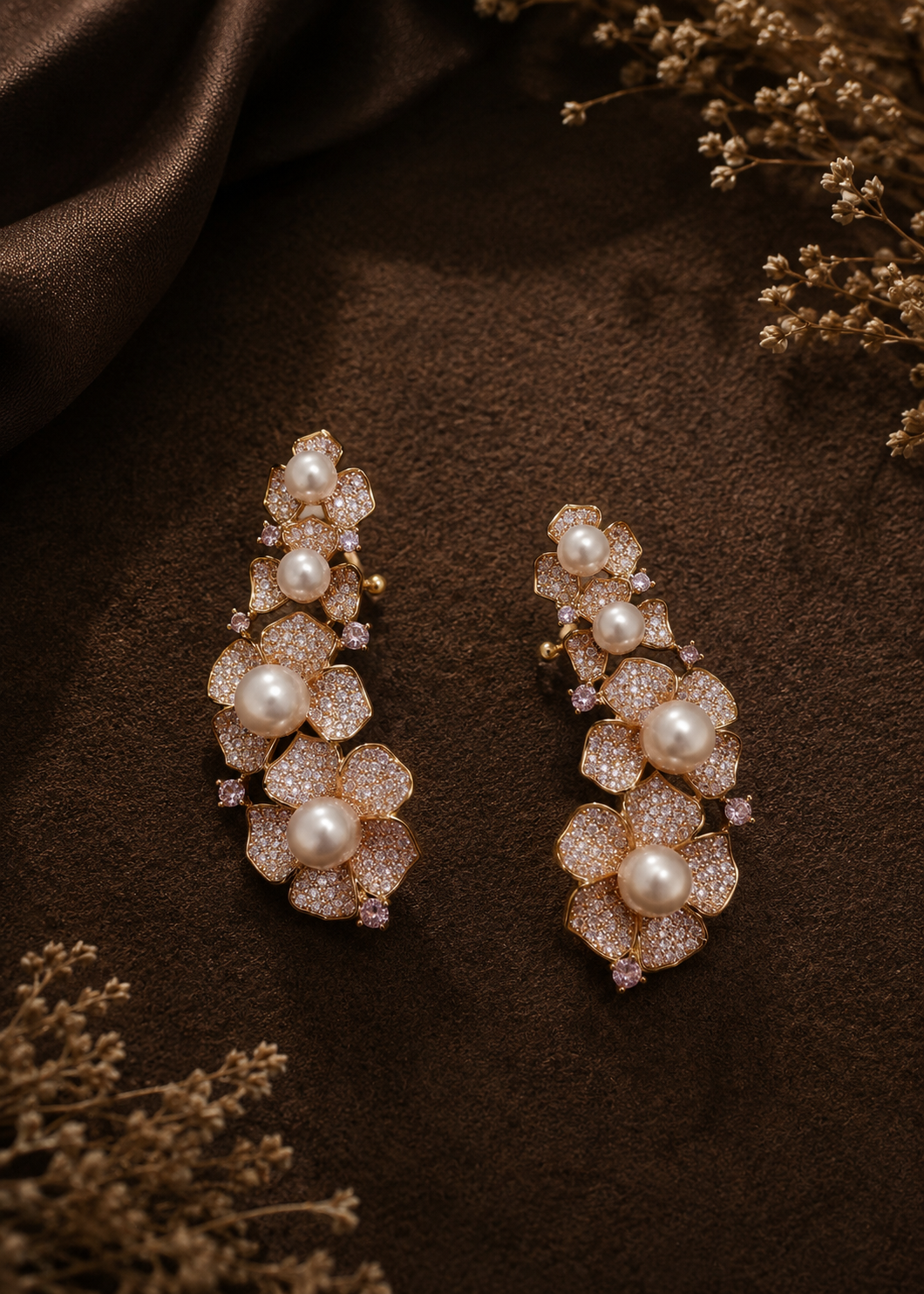 Rosalie Pearl Ear Cuff Set featuring gold floral cubic zirconia design with pearl accents on a luxury flat lay background.