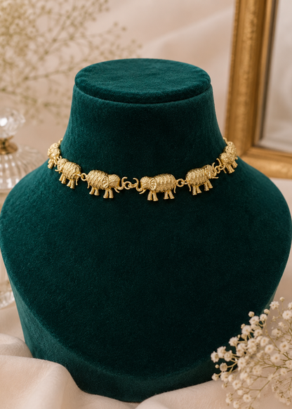 Royal Elephant Necklace Set featuring intricately crafted gold elephant motif necklace on green jewelry display.