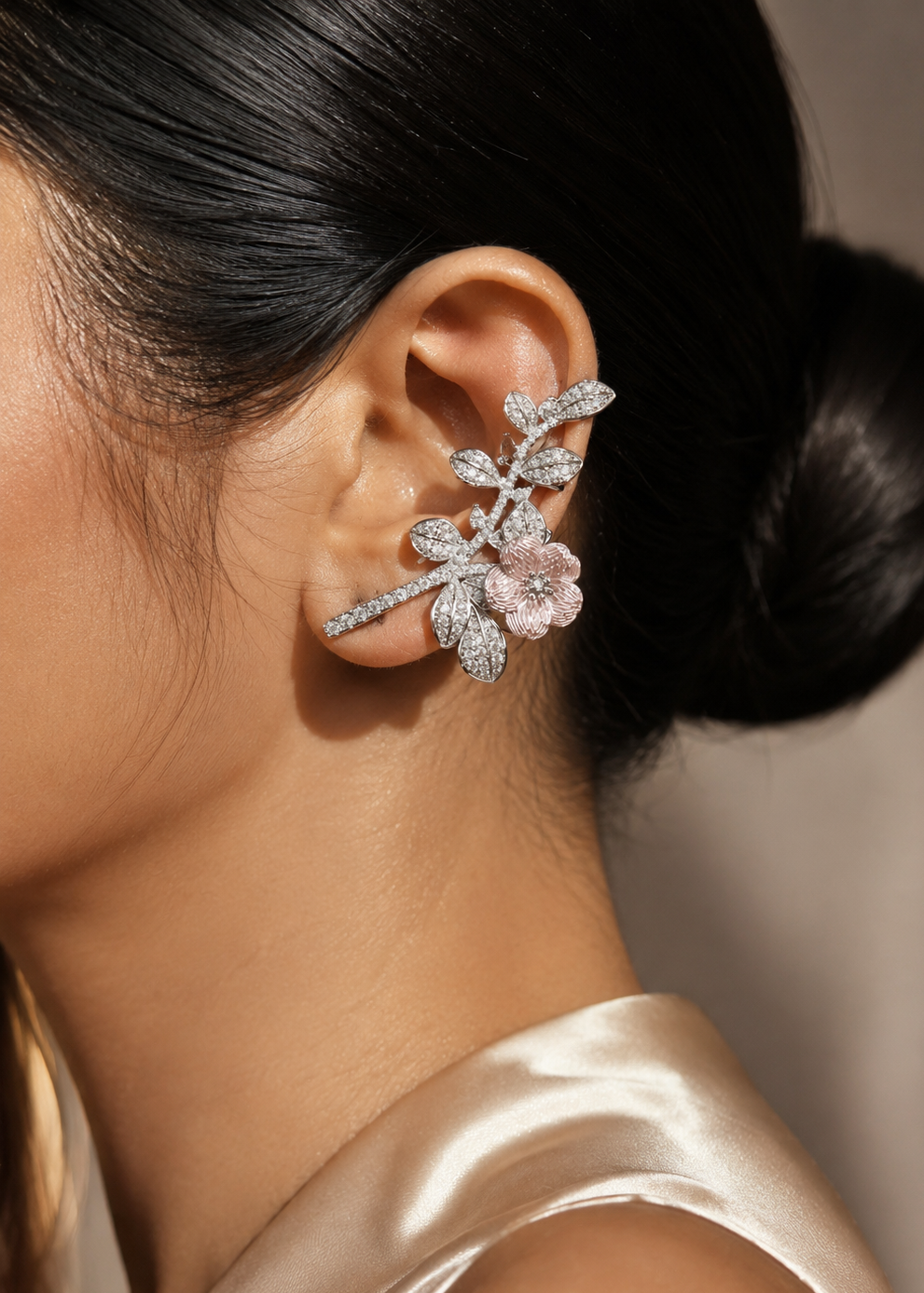 Model wearing Sakura Bloom silver floral statement ear cuff with pink enamel flower and crystal leaf design.