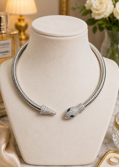 Serpentine Silver Crystal Necklace displayed on a jewelry bust featuring silver finish and sparkling crystal detailing.