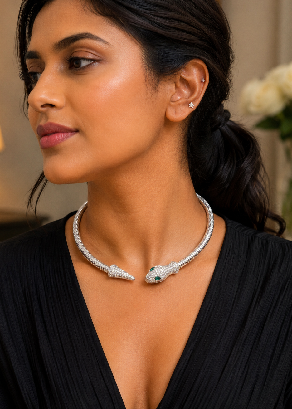 Model wearing Serpentine Silver Crystal Necklace with dazzling crystal snake design and emerald green eyes.