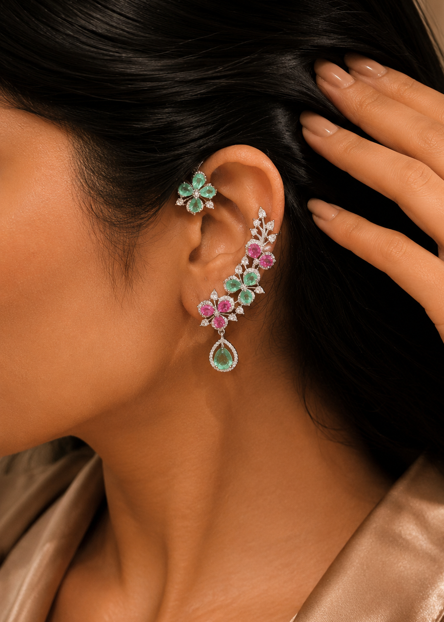 Model wearing Verdelle CZ Floral Ear Cuff Set featuring emerald green and ruby pink floral stones with sparkling cubic zirconia.